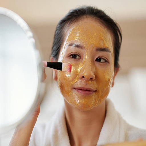 Girl applying brightening mask