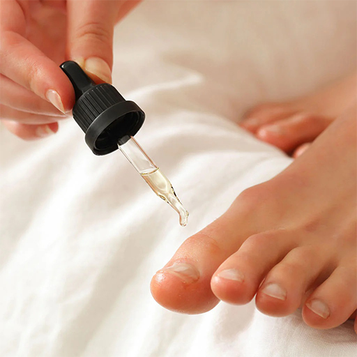 Applying cuticle oil on feet during a pedicure